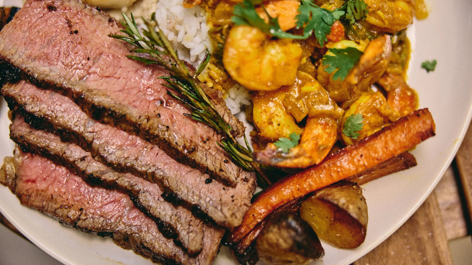 Wood-Fired Tomahawk Ribeye, Curried Prawns & Roasted Veg – Gozney