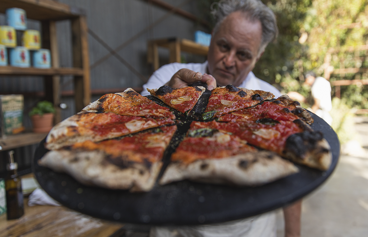 Chris Bianco holding pizza on server