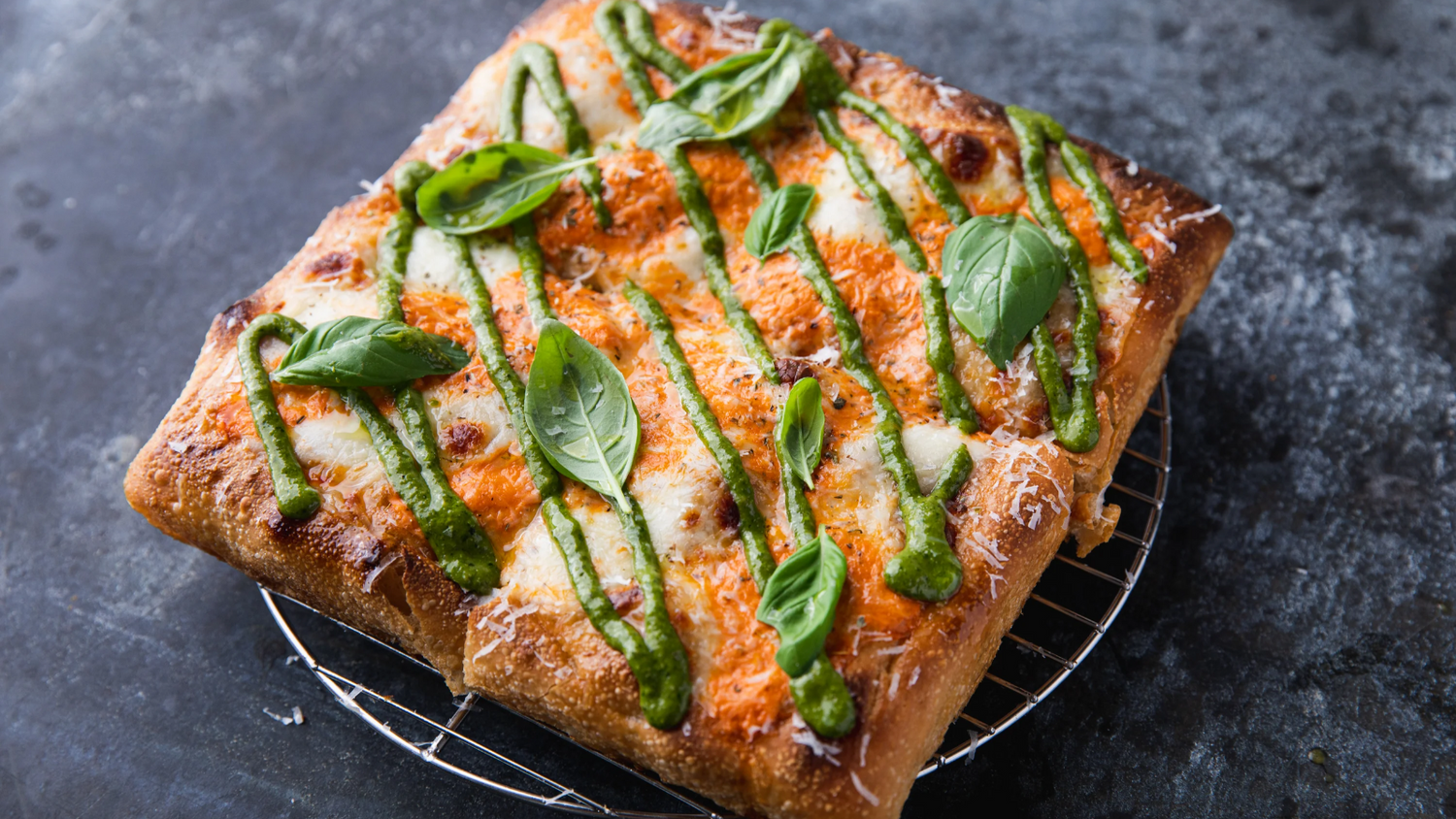 Sicilian Pizza topped with basil and pesto
