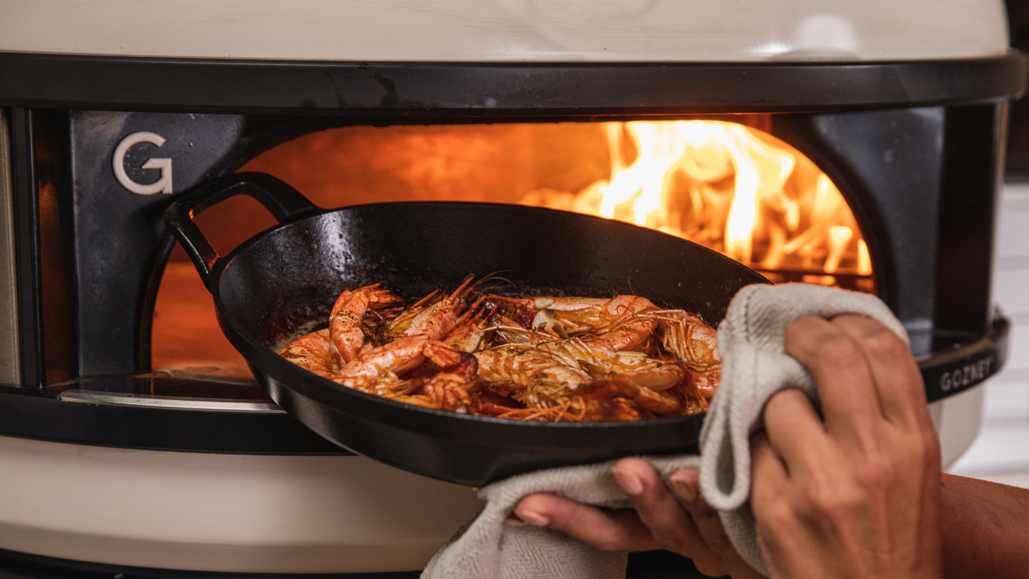 Prawns in cast iron pan pulled from Gozney Pizza Oven recipe poster image