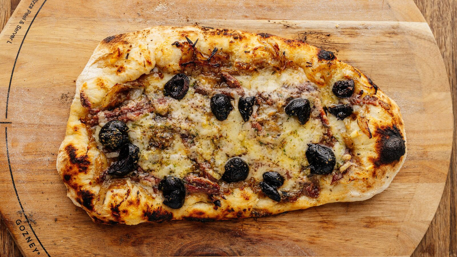 Pissaladière on a wooden cutting board
