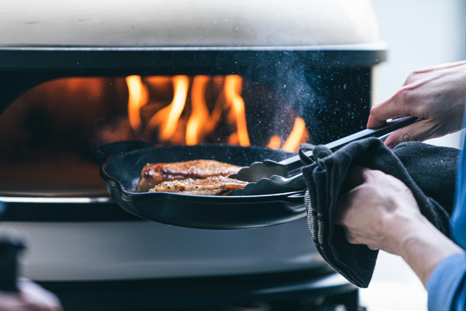 Pork Chop placed into Gozney Oven in cast iron pan recipe poster image